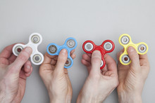 Hands Holding Popular Fidget Spinner Toy
