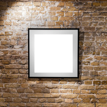 Empty Frame On Light Brick Wall. Blank Space Poster Or Art Frame Waiting To Be Filled. Square Black Frame Mock-Up