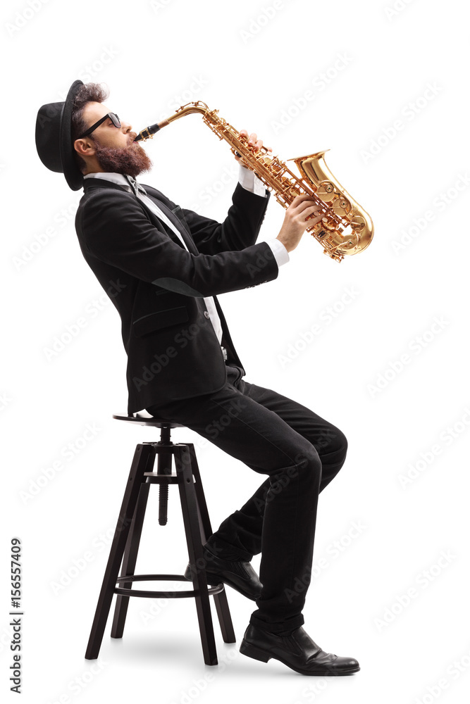 Jazz musician seated on a chair playing a saxophone - obrazy, fototapety, plakaty 