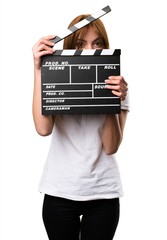 Wall Mural - Beautiful young girl holding a clapperboard