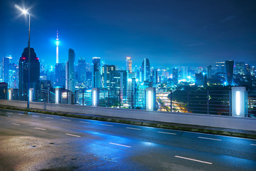 Wall Mural - Empty side view asphalt with modern city skyline , night scene ,Kuala Lumpur , Malaysia .
