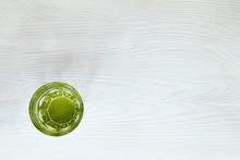 Ecological Drink/ Clean Water In A Green Glass On A White Wooden Table Top View