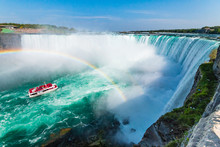 Hornblower Boat Full Of Tourists Under Rainbow Sprayed By Horseshoe Waterfall, Niagara Falls, Ontario, Canada