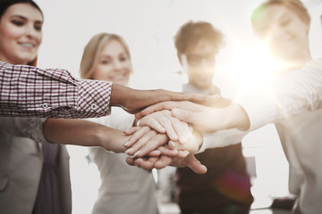 Poster - happy business team with hands on top at office