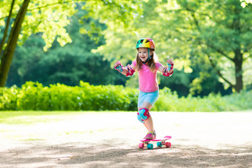 Wall Mural - Child riding skateboard in summer park