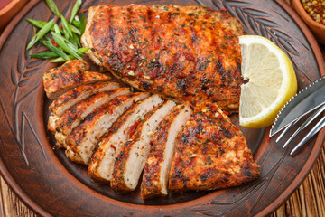 Chicken breast, roasted on the fire with spices and sauce on the table. The gourmet dinner. Selective focus. Top view