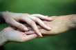 Young couple holding hands; love concept; selective focus background.