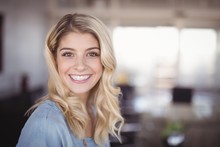 Smiling Business Woman Standing In Creative Office