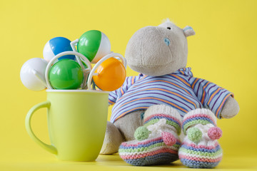 Hippopotamus toy and green cup