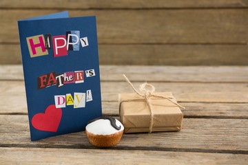 Wall Mural - Happy fathers day greeting card with gift box on table