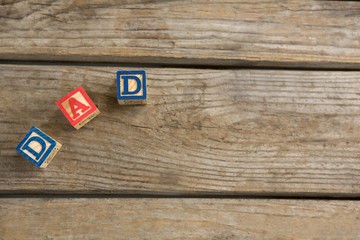 Wall Mural - Overhead view of cube shapes with text dad on table