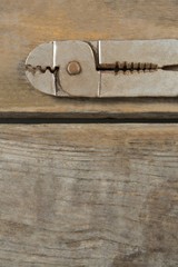 Wall Mural - Overhead close up of pliers on table