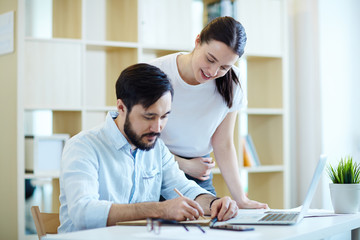 Sticker - Portrait of modern man and woman dressed in casual clothes collaborating of project  in office