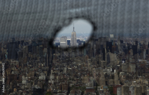 The Empire State Building Is Seen Through A Hole In The Netting