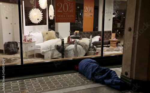 A Homeless Man Sleeps Outside A Furniture Shop On Tottenham Court