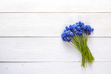 Bouquet Of Blue Muscaries Flowers On White Wooden Background. Place For Text. Top View.