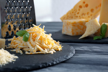 Wall Mural - Slate plate with different grated cheese on table