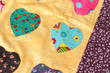 Patchwork quilt with heart print. Part of patchwork quilt as background. Handmade.