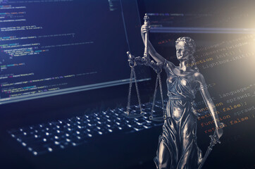 Justice statue with code on monitor device in background