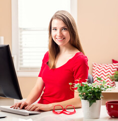 Wall Mural - Young woman sitting at her desk