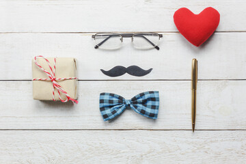 Wall Mural - Top view Happy Father day.flat lay accessories with red heart,mustache,vintage bow tie,present,pen on rustic white wooden background.