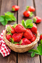 Fresh Strawberry In Basket On Wooden Rustic Table, Closeup. Delicious, Juicy, Red  Berries. Healthy Eating.