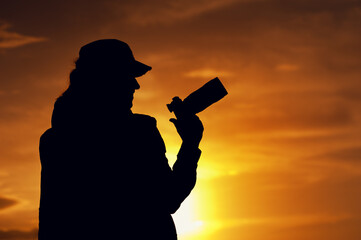 Wall Mural - Silhouette of professional female photographer