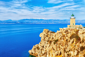 Lighthouse at the cliff by Ionian sea shore in Greece, Europe.