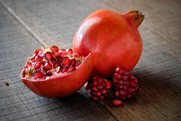 Wall Mural - Ripe pomegranate fruit on wooden vintage background.