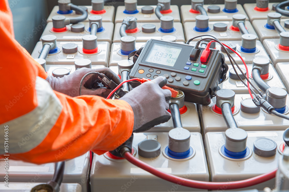 Electrician specialist inspect, check voltage and internal resistance ...