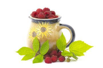 Wall Mural - raspberries in clay jug on white background