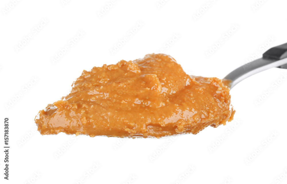 Delicious peanut butter in spoon isolated on white