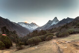 Fototapeta Góry - Sunrise in Himalayas. Ama Dablam, Nuptse, Lhotse and Everest in first rays of sun. Two eight-thousander peaks. View from Tengboche. Sagarmatha National Park, Solukhumbu District in Nepal, Asia. 
