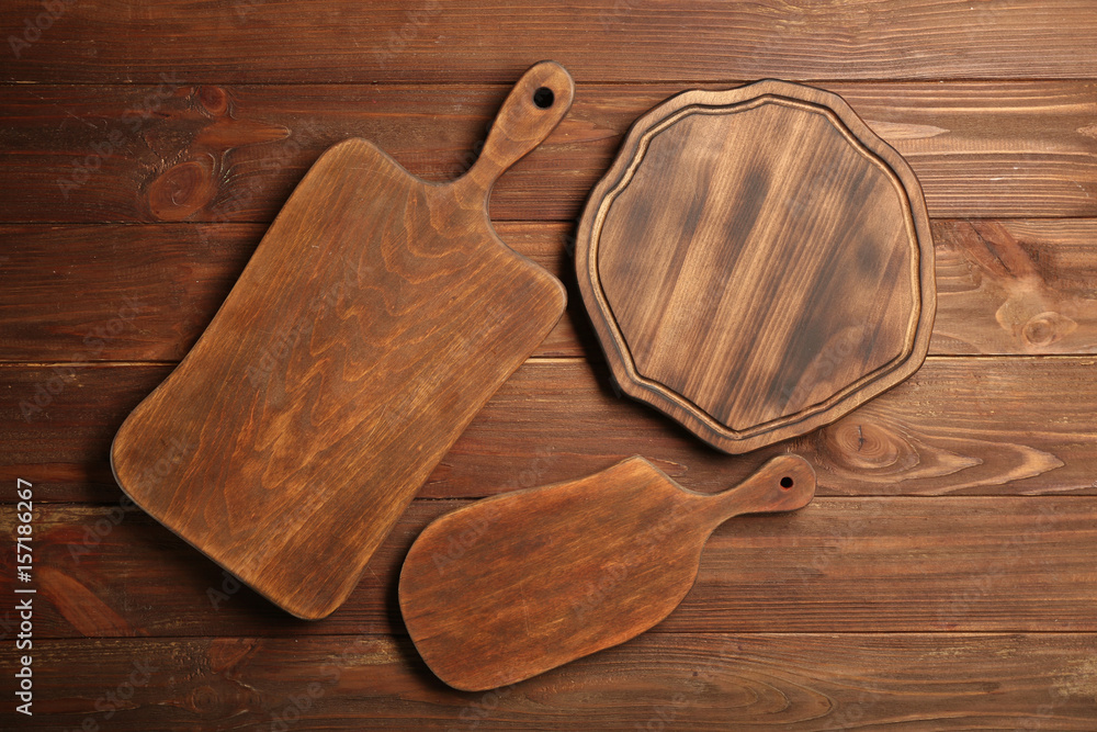 Set of cutting boards on wooden background