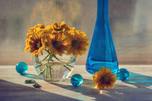 Bouquet Of Yellow Chrysanthemums On The Window . Blue Bottle And Glass Balls. Still Life.
