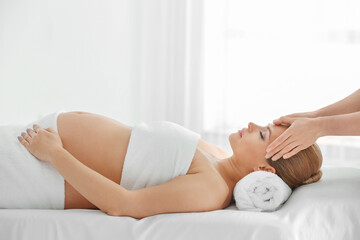 Poster - Young beautiful pregnant woman having massage in spa salon