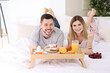 © Africa Studio - Happy couple having breakfast in bed