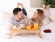 © Africa Studio - Happy couple having breakfast in bed