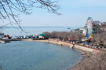 Wall Mural - Amusement park with a wheel on the beach in Vladivostok