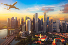 Travel, Transportation Concept - Airplane Flying Over Singapore City In Morning Time