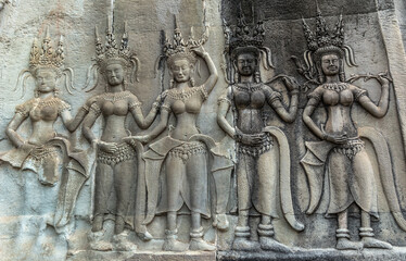 Wall Mural - Detail of a Stone Carved Relief in the famous Angkor Wat in Cambodia and the largest religious monument in the world. Location: Siem Reap, Cambodia. Artistic picture. Beauty world.