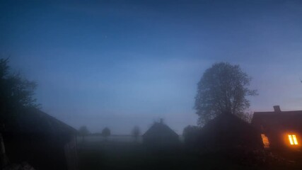 Wall Mural - Night timelapse of misty fog blowing over building  at dusk. Night sky with stars.