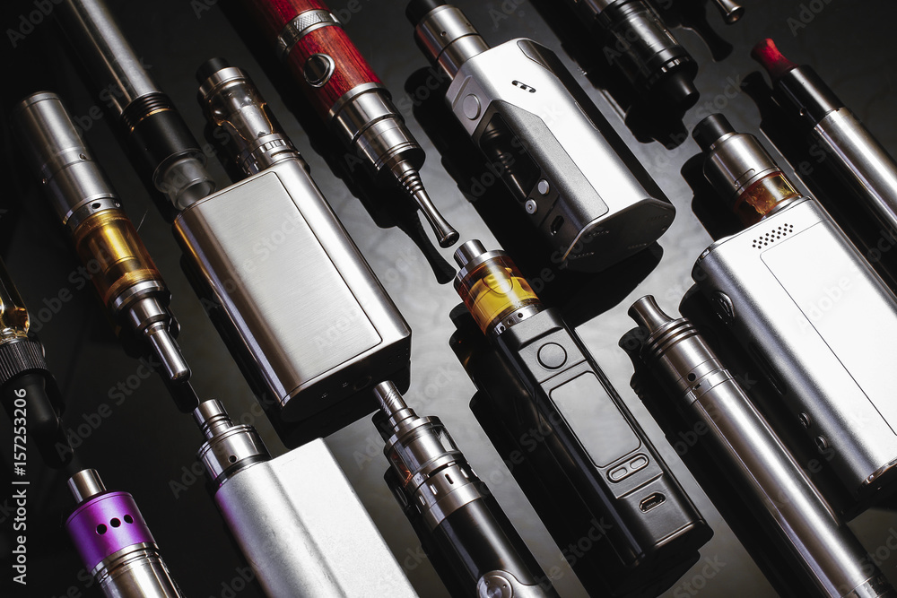 Popular vaping device mod.Upgrade parts for modern vaporizer e-cig  device,spare parts.New device model,micro coil clearomizer.Quit smoking  nicotine cigarette,start vaping safe ecig vape Stock Photo