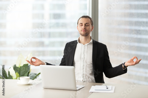 Relaxed Corporate Man Sitting With Closed Eyes Contemplating At