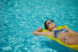 © ZoomTeam - A woman in the pool floats on a blown mattress