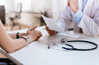 © bnenin - Doctor talking with patient for medical diagnosis.