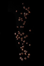 Roasted Coffee Beans Over Black Background. Isolated