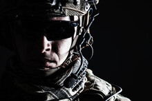 Elite Member Of US Army Rangers In Combat Helmet And Dark Glasses. Studio Shot, Dark Black Background, Looking At Camera, Dark Contrast