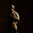© Getmilitaryphotos - Elite member of US Army rangers in combat helmet and night vision device. Studio shot, dark black background, looking at camera, dark contrast