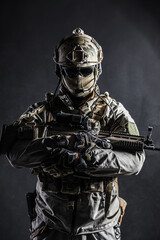 Sticker - Army soldier in Protective Combat Uniform holding Special Operations Forces Combat Assault Rifle. Studio shot, dark contrast, cropped, black dark background